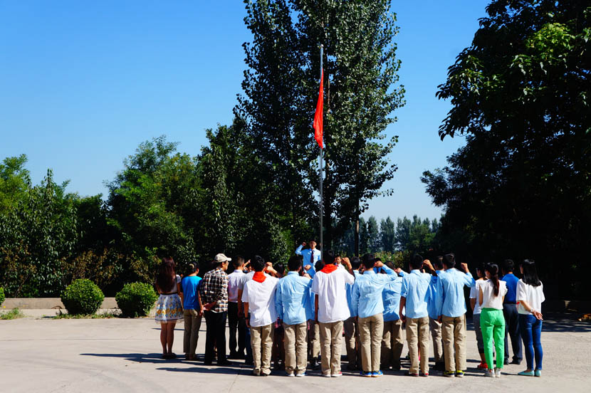 More than 30 students gather for a flag-raising ceremony at Linfen Red Ribbon School, Shanxi province, Sept. 1, 2016. Fan Yiying/Sixth Tone