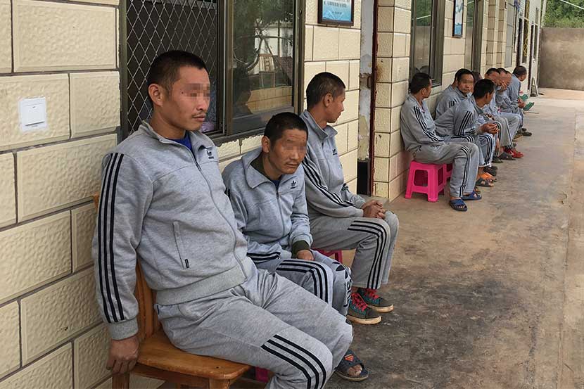 Mentally disabled men who are unable to remember their home addresses sit outside a rescue center in Xuanwei City, Yunnan province. Peng Yu/Sixth Tone