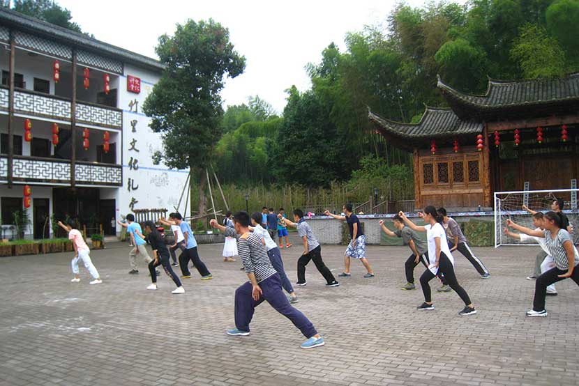 Students practice martial arts outdoors at Wenli School in Wenzhou, Zhejiang province, Sept. 9, 2016. Cai Yiwen/Sixth Tone