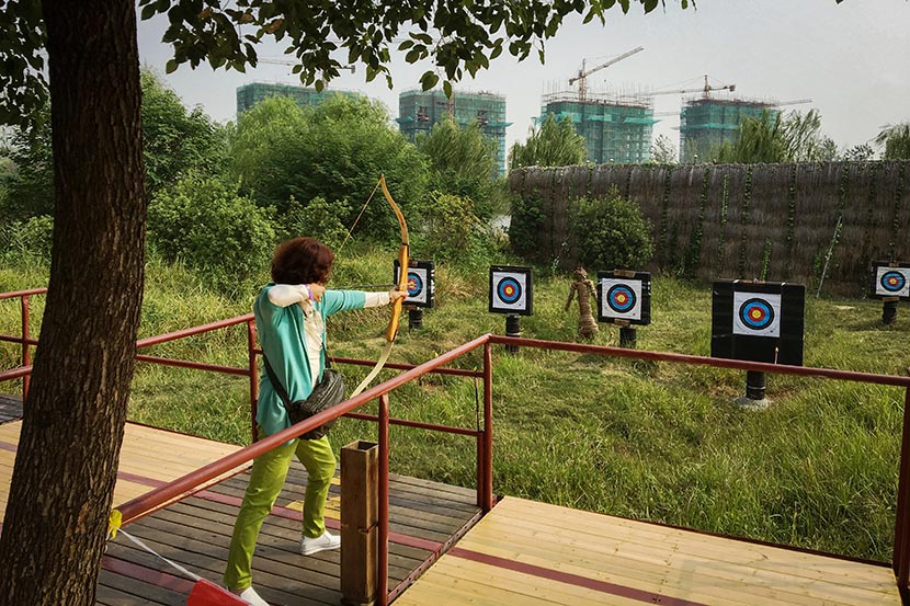 Xie Wenying practices archery at Tianle Lake Resort in Yangzhou, Jiangsu province, Sept. 23, 2016. Fan Yiying/Sixth Tone