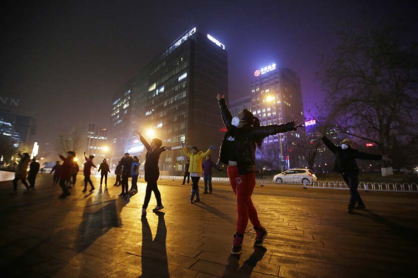 Women perform square-dancing in Beijing, Dec. 7, 2015. Jason Li/Reuters/VCG