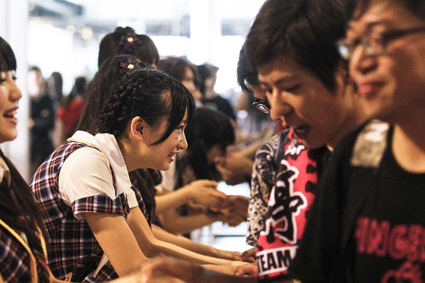Members of SNH48 greet their fans at an event in Shanghai, May 25, 2014. Yong Kai/Sixth Tone 