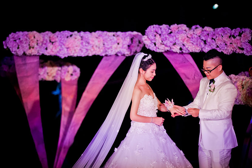 Aries Liu puts a ring on Yao Mei’s finger during their wedding in Sanya, Hainan province, Sept. 14, 2016. Courtesy of Aries Liu