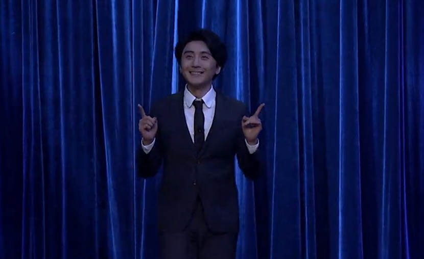  A screenshot from ‘The Vicious Liang Huan Show’ shows host Liang Huan appearing on stage with a smile.