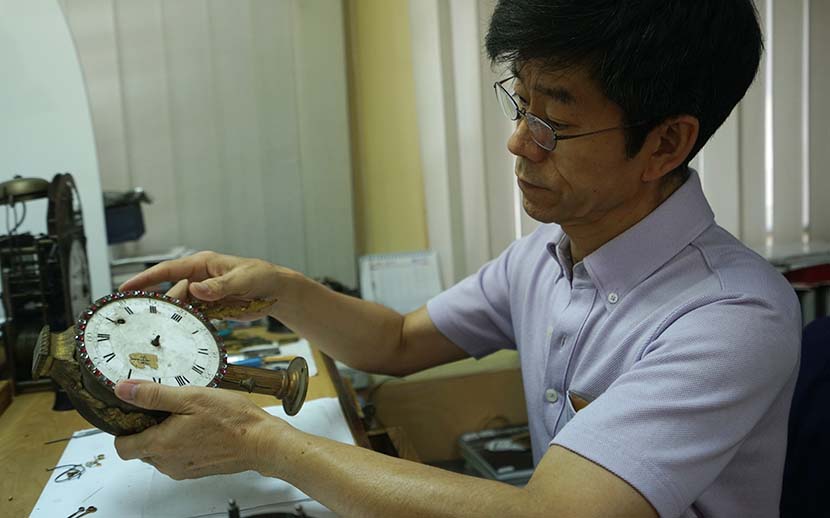 Wang Jin repairs a clock in his studio at the Forbidden City, Beijing, July 28, 2016. Courtesy of the documentary's crew
