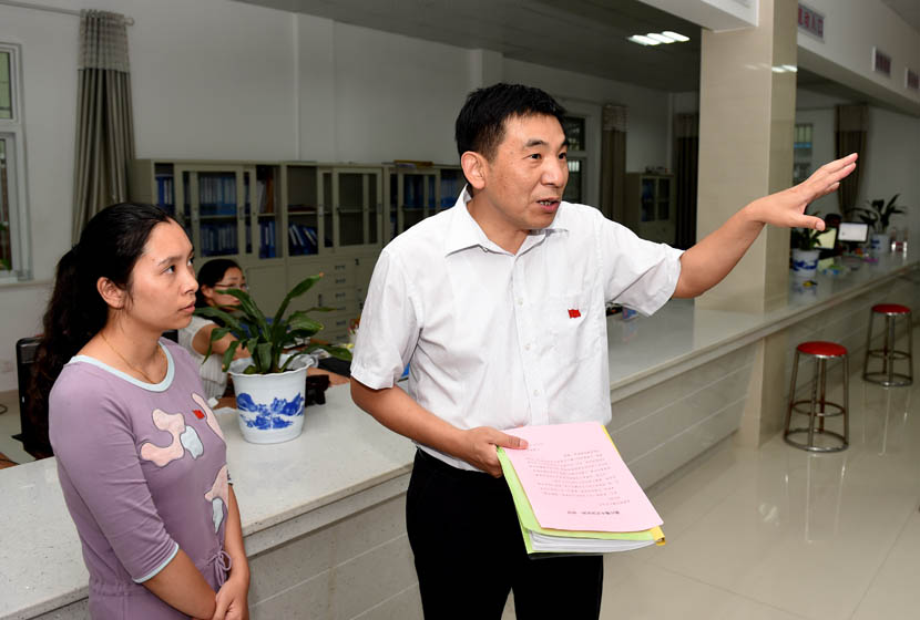 Wu Aiguo gestures during a tour of a community center in Guangde County, Anhui province, June 26, 2015. Liu Junxi/Xinhua