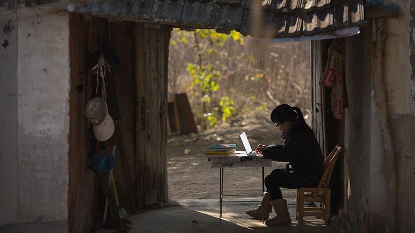 A still frame from ‘Still Tomorrow’ shows Yu Xiuhua typing on her computer. Courtesy of Fan Jian