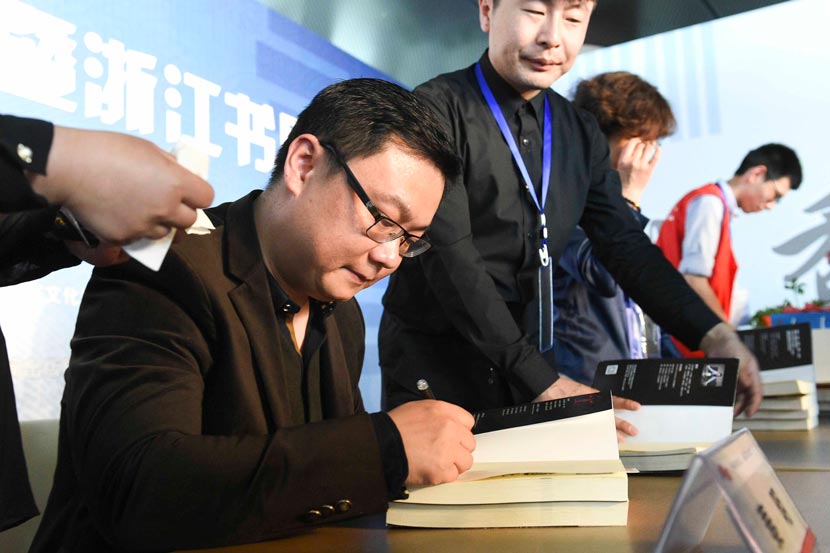 Author Qin Ming signs books for fans during a literary event in Hangzhou, Zhejiang province, April 26, 2015. IC