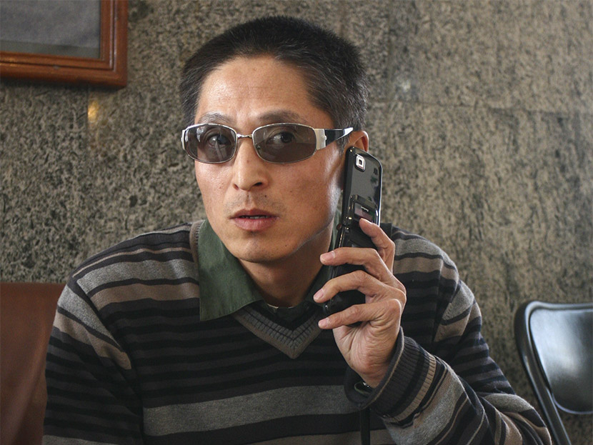 Tao Shaoming, a former distance-running coach for the Chinese national team, talks on the phone after the 2007 Beijing International Marathon, Beijing, Oct. 21, 2007. ChinaFotoPress/VCG