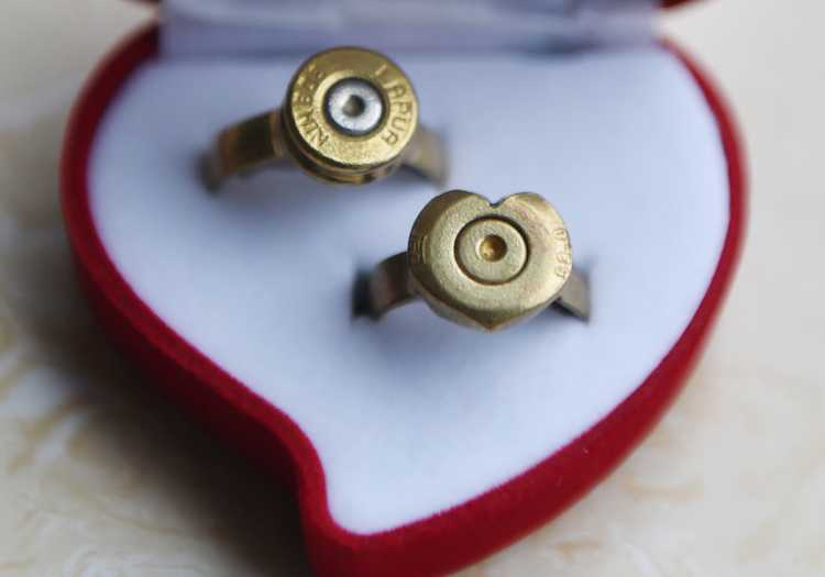 Two wedding rings crafted from bullets sit in a display box, Tonghua, Jilin province, Aug. 30, 2016. VCG