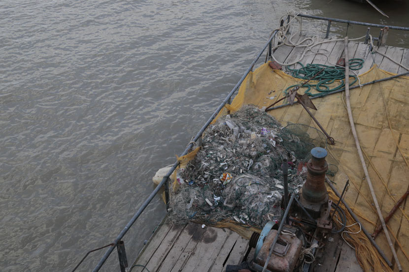 Trash has become caught in the nets of fishermen on the Yangtze River in Taicang, Jiangsu province, Dec. 27, 2016. Li You/Sixth Tone
