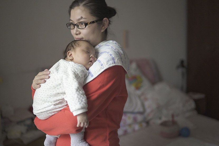 Wang Rui holds her son, who was born prematurely, at her home in Shanghai, March 5, 2017. Wu Yue/Sixth Tone