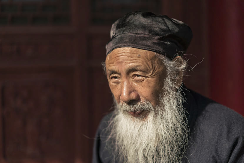 Ren Farong, one of the highest-ranking Taoist masters in China, poses for a photo inside the courtyard at Louguantai Temple, Tayu Village, Shaanxi province, Jan. 12, 2017. Thomas Cristofoletti for Sixth Tone