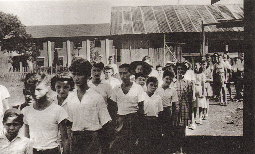 Lunghwa Academy students stand in line, with the camp’s G Block residences visible in the background. Courtesy of Betty Barr