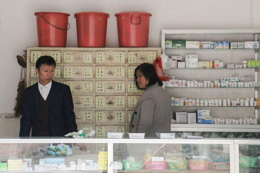 Zhang Hong and his wife stand in their clinic in Zhengdongbao Village, Guangxi Zhuang Autonomous Region, March 9, 2017. Cai Yiwen/Sixth Tone