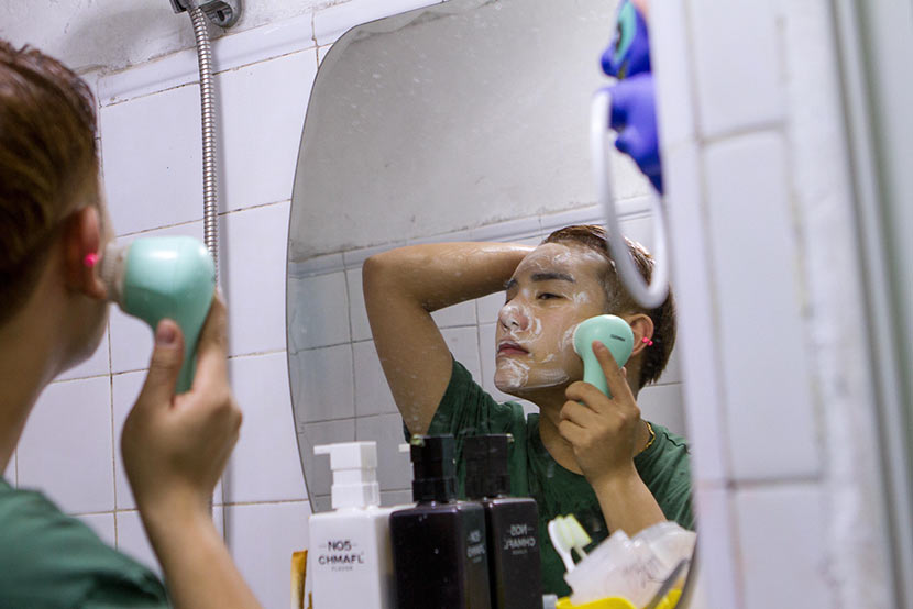 A young man who has undergone several cosmetic surgeries washes his face in Changchun, Jilin province, April 11, 2016. Lan Yang/IC