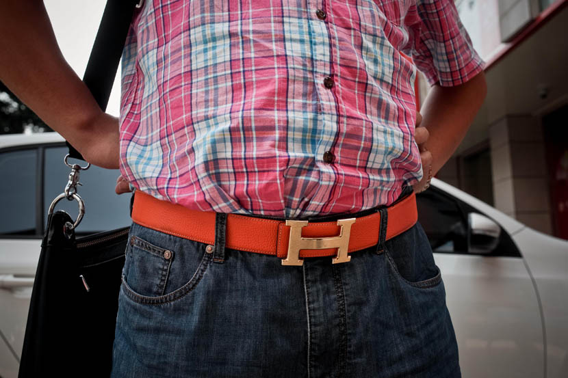 A mine owner displays his Hermès designer belt in Shenmu, Shaanxi province, July 22, 2013. Zhou Pinglang/Sixth Tone