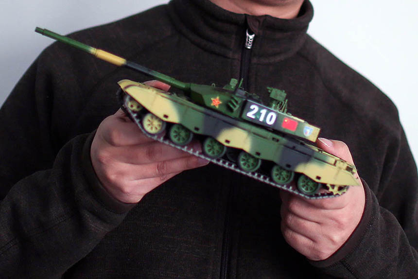 Iron Blood founder Jiang Lei holds a model tank at his office in Beijing, Jan. 19, 2016. Quan Yi/Sixth Tone