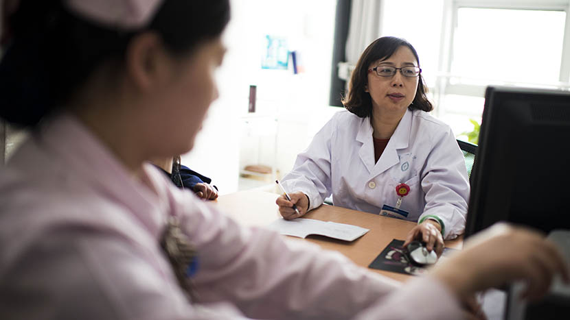  A senior doctor, Guo Yihong, in her office, in Zhengzhou, Henan province, March 24, 2016. Guo spends four to five minutes on average with each patient. She sees 80 to 90 patients per half day. Wu Yue/Sixth Tone