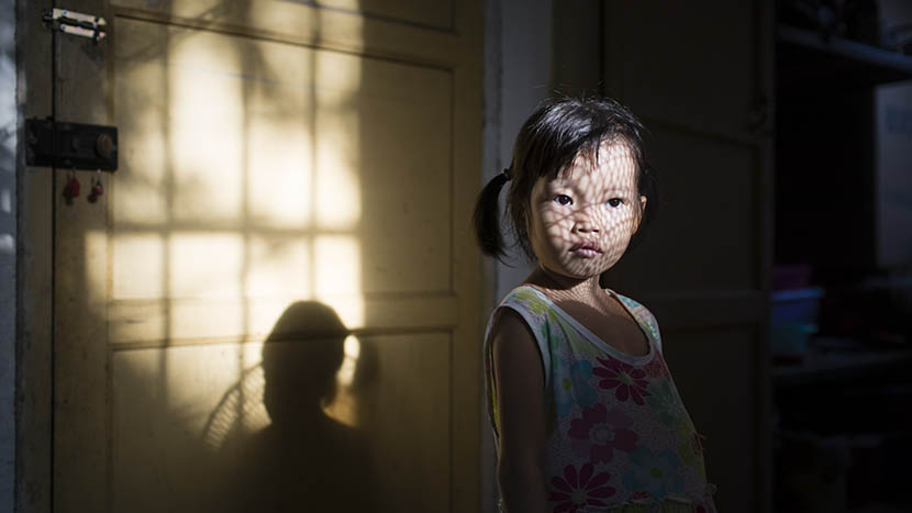 Dongmei stands in a room her mother has rented for Dongmei’s treatment in a suburban village nearby Nanning, Guangxi Zhuang Autonomous Region, Sept. 19, 2015. Zhou Pinglang/Sixth Tone