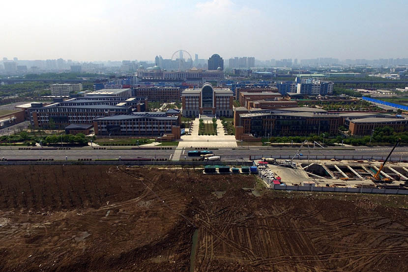 An aerial photo shows the new campus of Changzhou Foreign Languages School is next to the former site of Changlong’s factory in Changzhou, Jiangsu province, April 18, 2016. IC