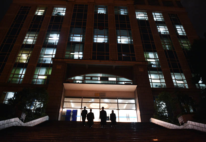 After a trial, four judges walk out of the Yunyang County People's Court building, Chongqing Municipality, Nov. 24, 2015. Rao Guojun/VCG