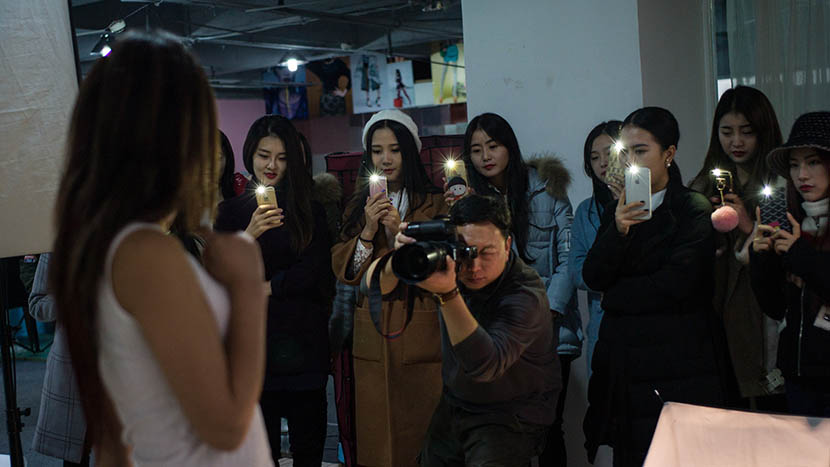 Taobao models are taught how to pose in front of a camera at a training center in Wuhan, Hubei province, Dec. 9, 2015. Ma Luyao/IC