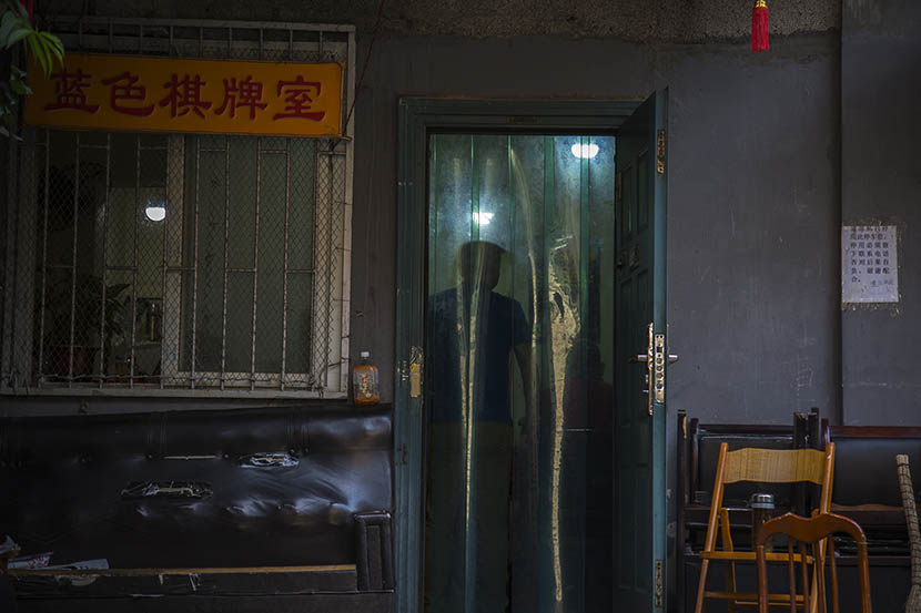 A man stands in the doorway of a mahjong parlor popular among older gay people, Changsha, Hunan province, May 16, 2016. Wu Yue/Sixth Tone