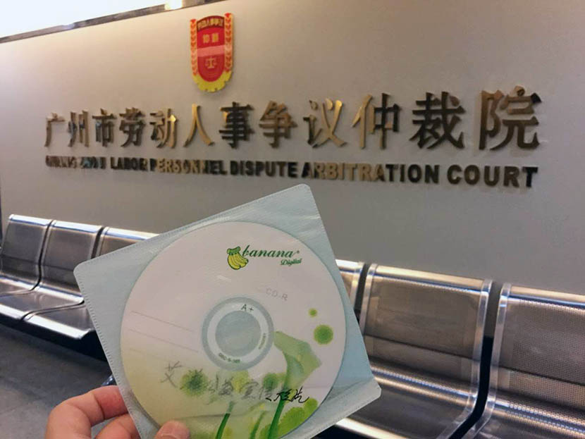 Lawyer Qiu Hengyu holds a disc containing an AIDS public service video at the Guangzhou Labor Dispute Arbitration Court, Guangdong province, June 12, 2016. Qiu Hengyu for Sixth Tone