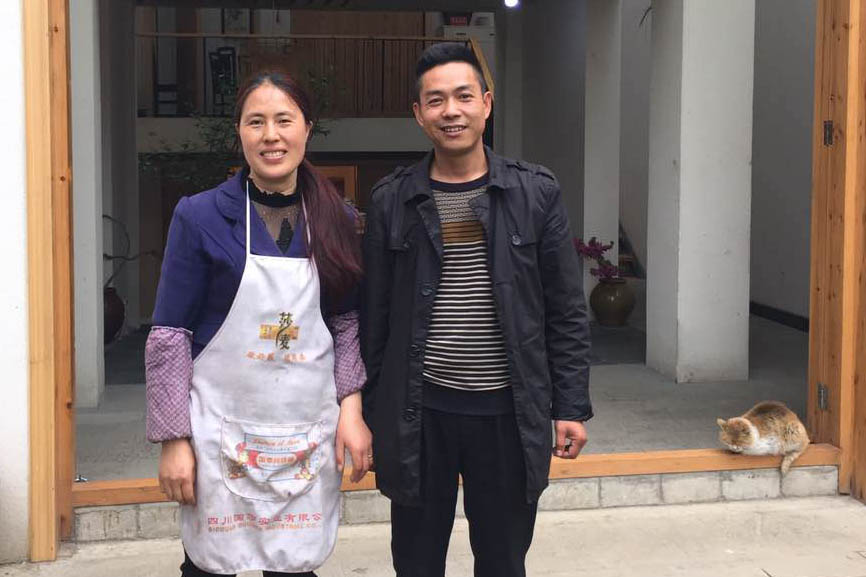 Tian Yuxia and her husband Li Dehua pose in front of the new house, ‘Sister Tian’s home’ in Xueshan, Sichuan province, April 11, 2016. Wu Haiyun/Sixth Tone