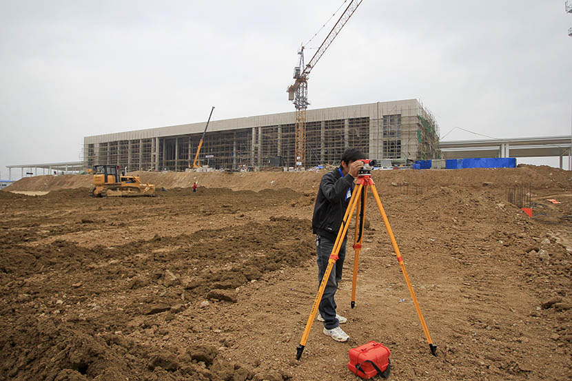 A worker surveys the land in front of the construction site of the Dingyuan high-speed rail station, Anhui province, May 27, 2011. Zhang Dong/Sixth Tone