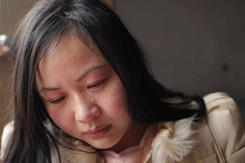A tear runs down Lin Chunhong’s face as she recalls her childhood in Linyi, Shandong province, March 8, 2016. Her adoptive mother remarried three times, and they were often destitute. Han Meng/Sixth Tone
