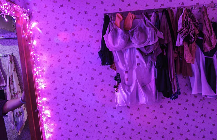 Tools of the trade hang inside the work apartment of sex worker ‘Miss F’ in Sham Shui Po, Hong Kong, Oct. 8, 2014. Chris Stowers/TNS/IC
