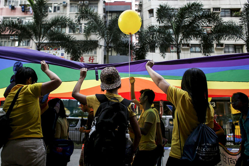 Participants hold up a rainbow banner during the annual gay pride parade in Hong Kong, Nov. 7, 2015. Bobby Yip/Reuters/VCG