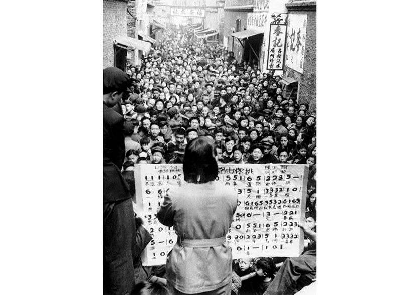 Members of a propaganda unit lead choral song in a residential lane, Shanghai, 1951-1952. Courtesy of ‘Old Photos’