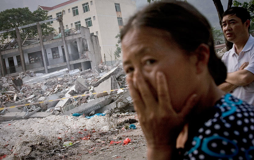 Parents mourn earthquake victims near the remains of Beichuan Middle School in Beichuan Qiang Autonomous County, Sichuan province, June 12, 2008. Alexander F Yuan/IC
