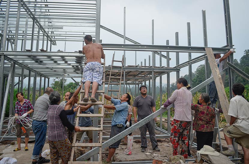 Villagers build a house with an earthquake-resistant light steel frame in Baishu Village, Sichuan province, Aug. 10, 2013. Courtesy of the One Foundation