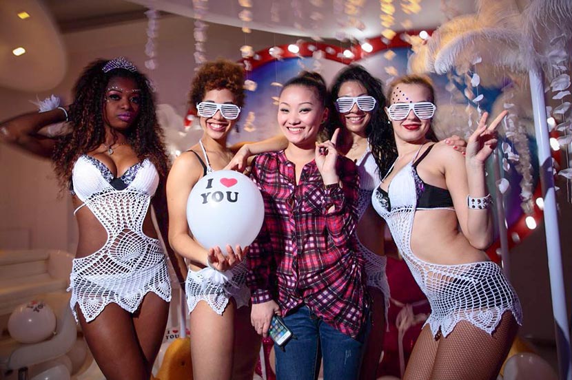 Wang Feng (middle) poses with a group of go-go dancers whom she manages in Changsha, Hunan province, 2013. Courtesy of Wang Feng
