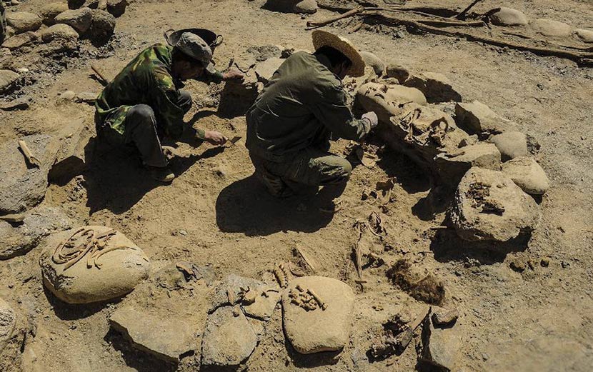 Members of an archaeological team work at the ruins of Quxman Tombs in Tashkurgan , Xinjiang Uyghur Autonomous Region, June 3, 2013. Shen Qiao/Xinhua