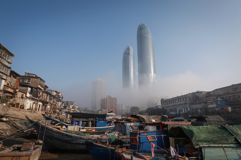 Small fishing boats fill Shapowei harbor before the redevelopment project, Xiamen, Fujian province, 2015. Chen Chaoyuan hung this photo at the entrance to his store. Courtesy of Chen Chaoyuan