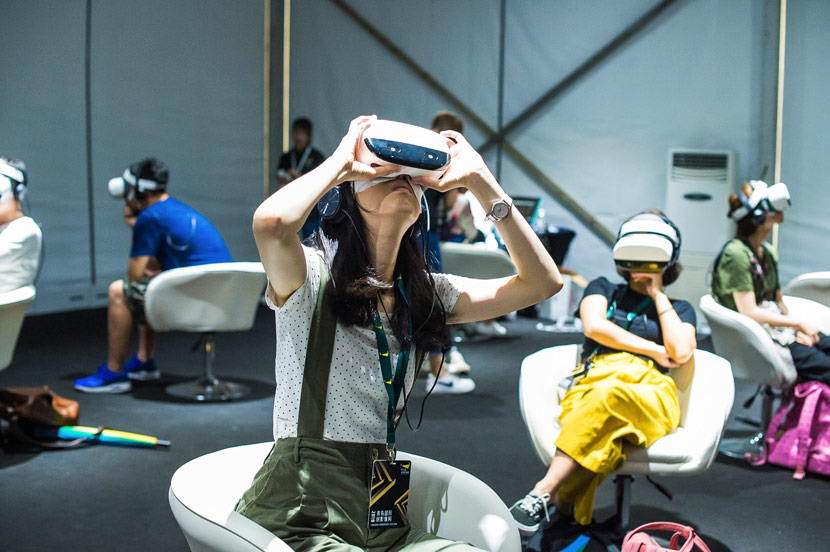 People watch VR videos using headsets during Sandbox Immersive Festival in Qingdao, Shandong province, June 25, 2018. Courtesy of Sandbox Immersive Festival