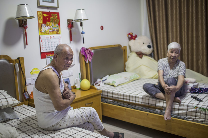 An elderly couple watches TV in their room at Sunshine Home in Hangzhou, Zhejiang province, Sept. 28, 2018. Chen Zhongqiu for Sixth Tone