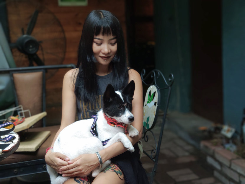 Xing Ruizhi holds her foster dog, Coco, in Jinan, Shandong province, Aug. 31, 2018. Fan Yiying/Sixth Tone