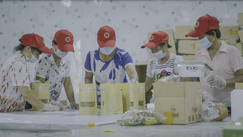Workers in a warehouse package products sold on Gan Youqin’s Taobao shop, Lingshan County, Guangxi Zhuang Autonomous Region, Sept. 30, 2018. Tang Xiaolan/Sixth Tone