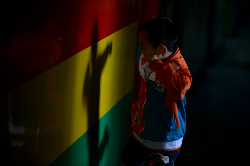 A boy plays with his shadow at a school for children with autism in Taiyuan, Shanxi province, April 3, 2013. Hu Yuanjia/VCG
