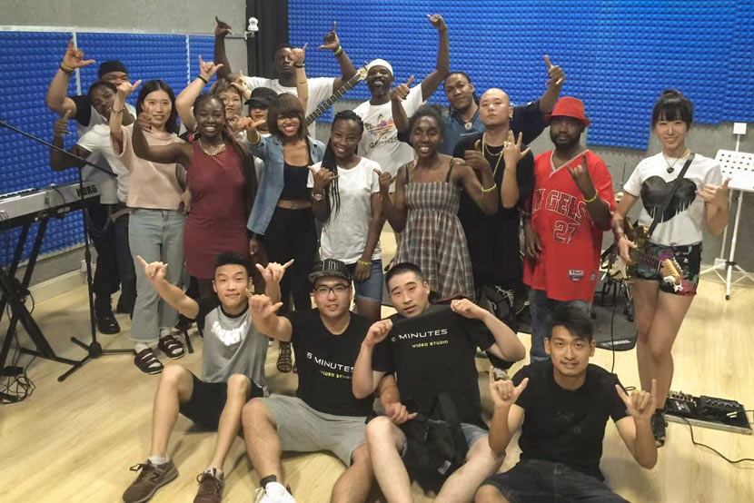 Isaac Eugene (back row with white bandana) poses for a photo with artists and technicians from Black China Music Company in Shanghai, 2017. Courtesy of Isaac Eugene