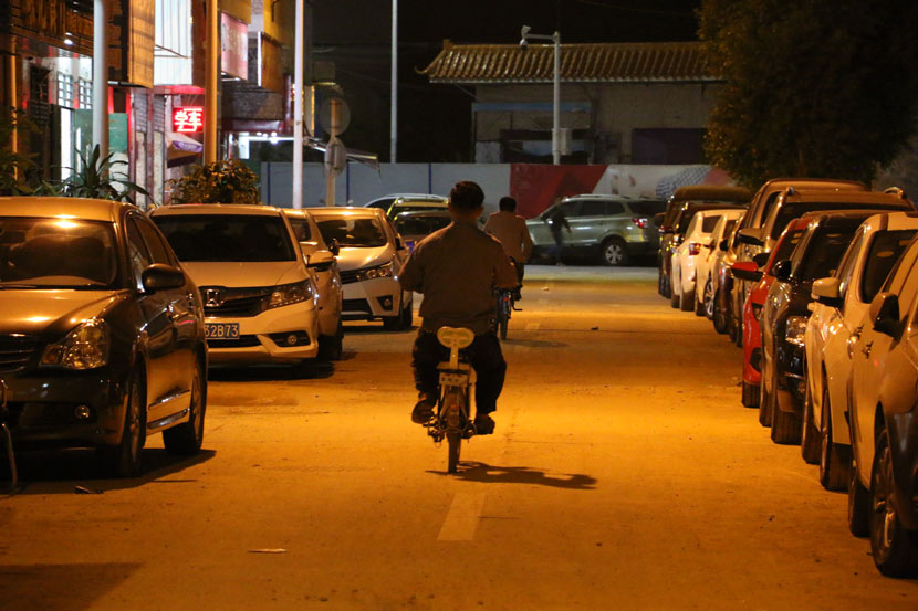 Tan Song’an rides an e-bike down a street in Shenzhen, Guangdong province, Nov. 3, 2018. Cai Yiwen/Sixth Tone