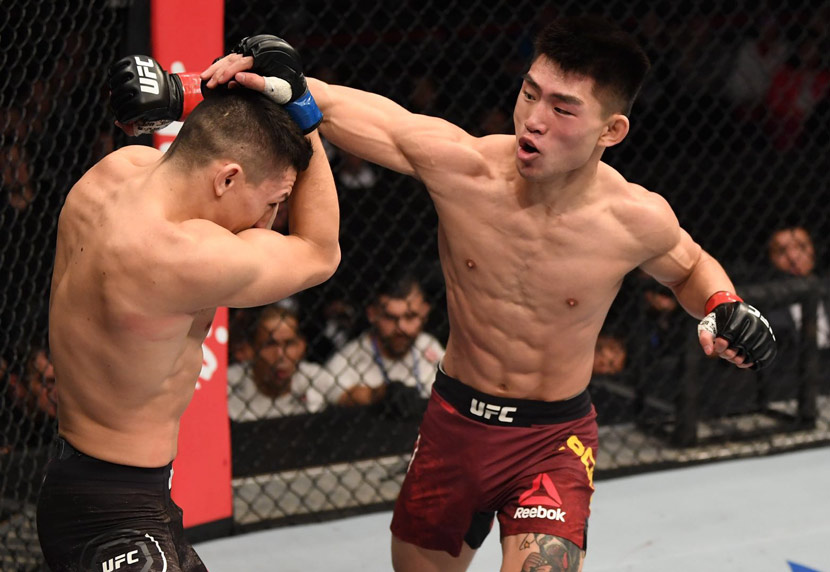 American mixed martial artist Vince Morales protects himself from a punch thrown by his Chinese opponent, Song Yadong, at a UFC Fight Night event in Beijing, Nov. 24, 2018. Courtesy of UFC