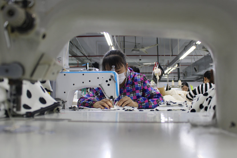 A worker operates a sewing machine at Banzuo Garment Manufacturing Inc. in Hangzhou, Zhejiang province, Nov. 5, 2018. Xue Yujie/Sixth Tone