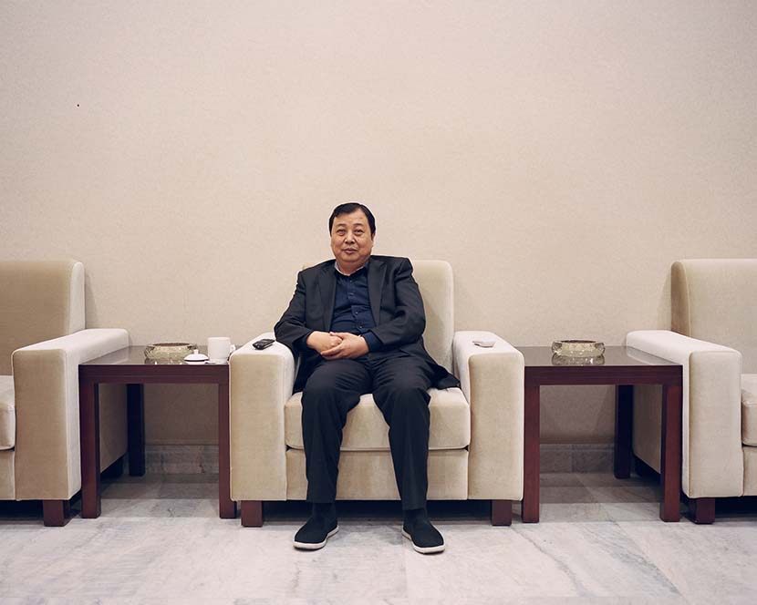 Huaxi’s Party secretary Wu Xie’en poses for a photo at a meeting room in Huaxi, Jiangsu province, 2018. Shi Yangkun/Sixth Tone